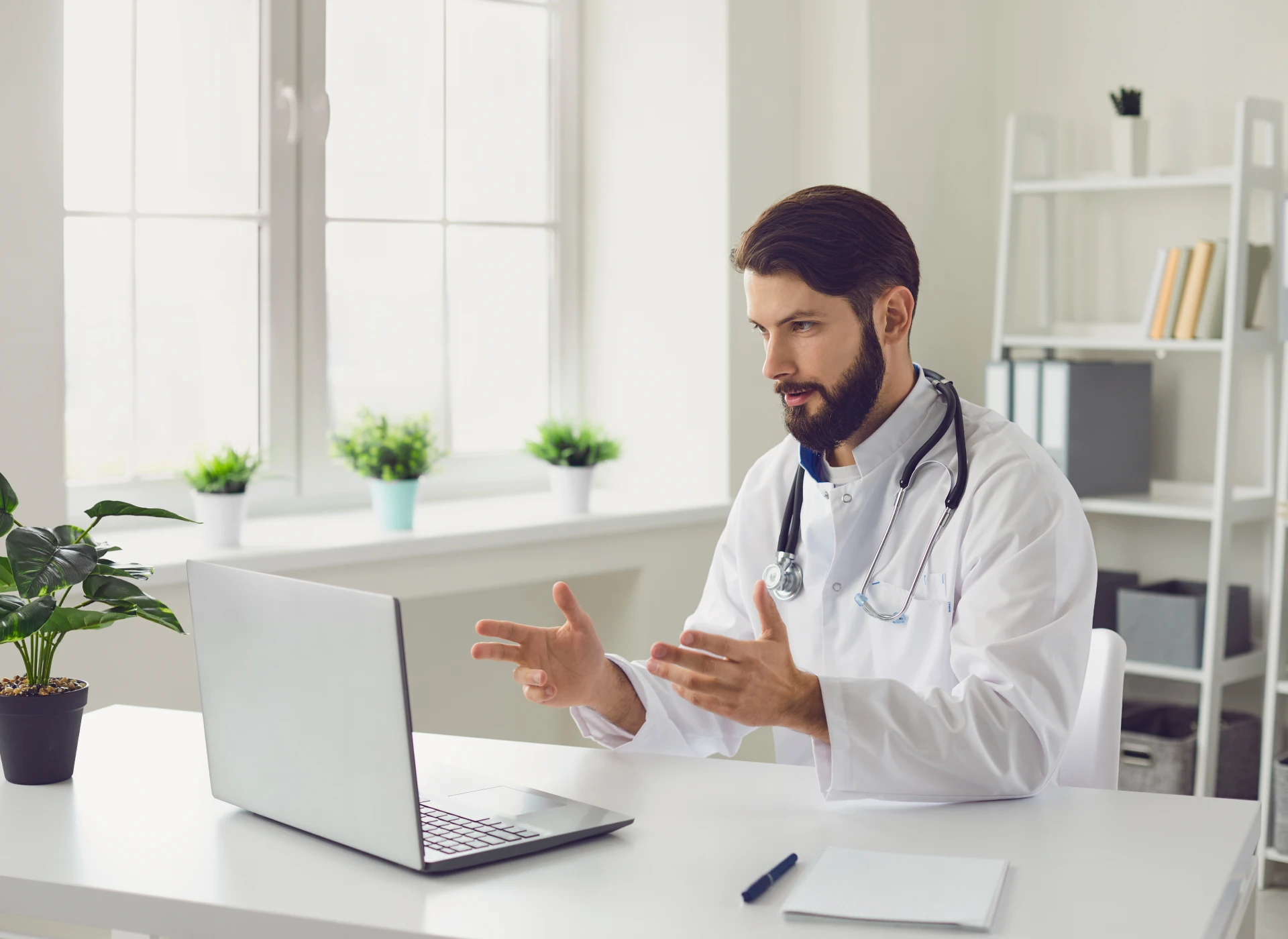 Doctor conducting video consultation on laptop