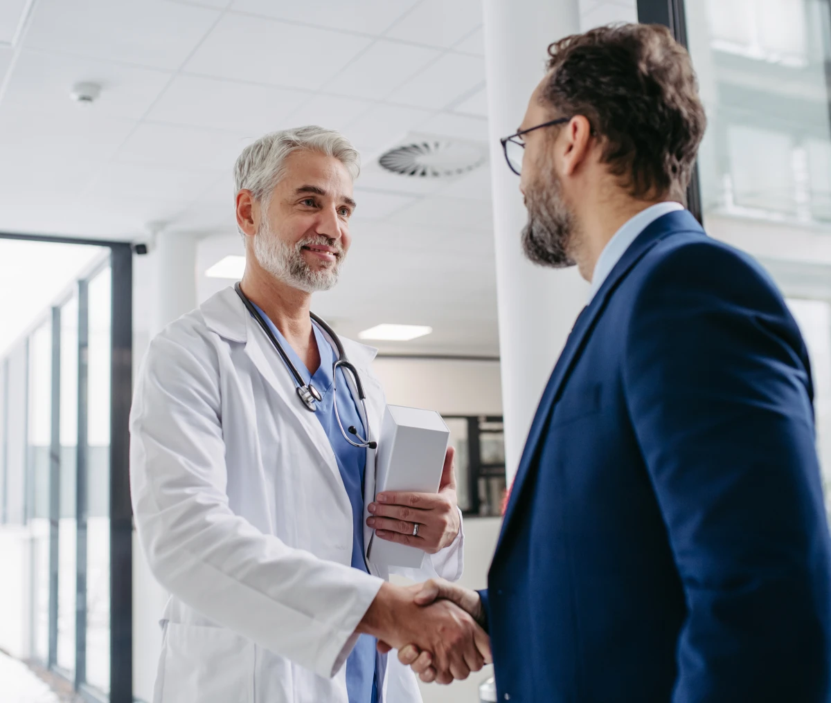 Doctor shaking hands with businessman